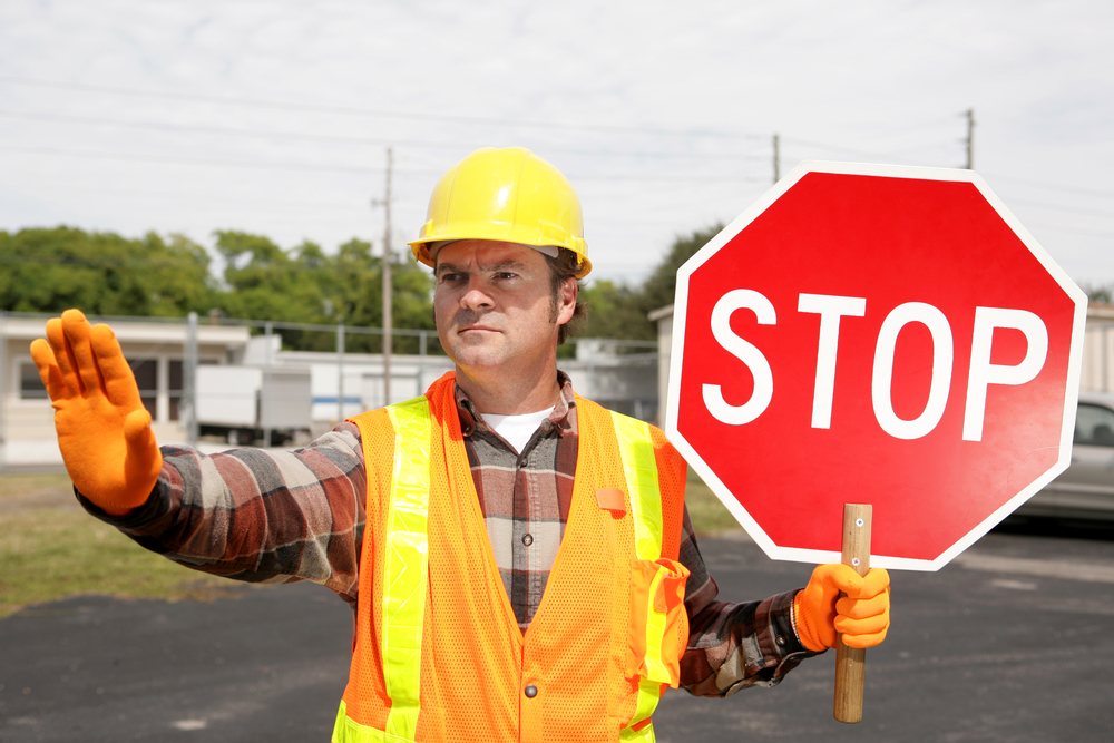 Flagger directing traffic in a work zone